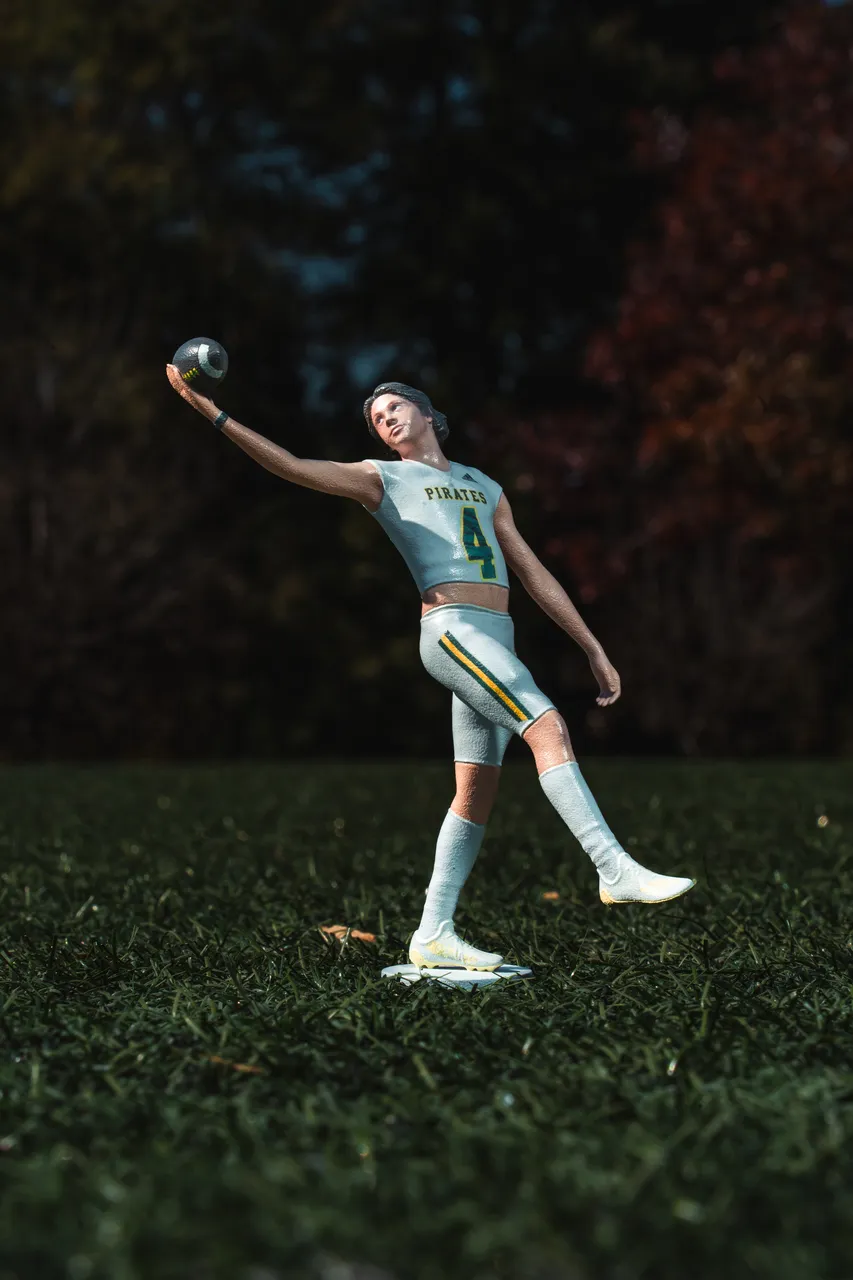 Detailed 3D-printed figurine of a football player in a Pirates jersey holding a football